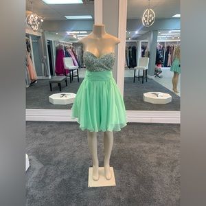 Mint. size 12. chiffon sequined bodice. ruched waist and ruffled bottom.